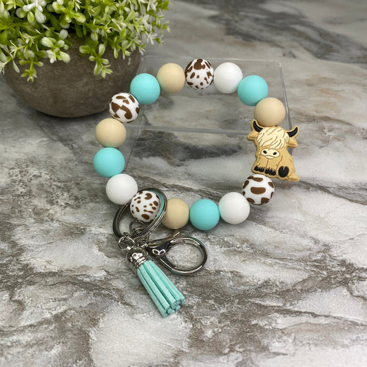 Silicone Bracelet Keychain - Turquoise Spot Highland Cow